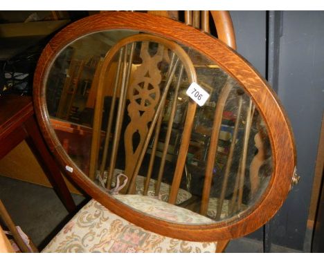 A 1930's oval oak framed mirror. COLLECT ONLY.