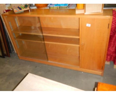 A 1950's oak book case with cupboard, COLLECT ONLY.Some marks to sides but generally in good condition for age with good colo