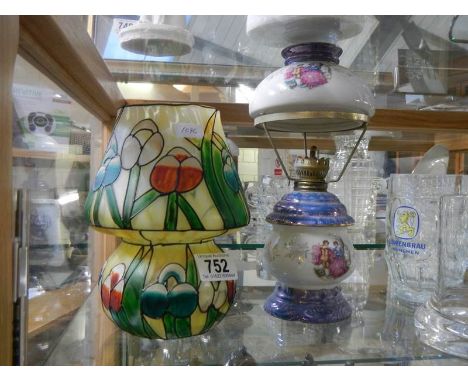 A small ceramic oil lamp and a tiffany style candle lamp.