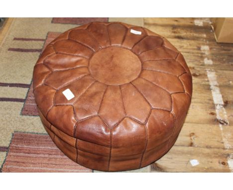 A vintage mid-century leather foot stool
