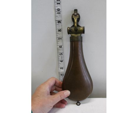 A rare copper powder flask with a measuring device 