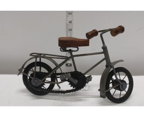 A vintage style metal model of a bicycle. 