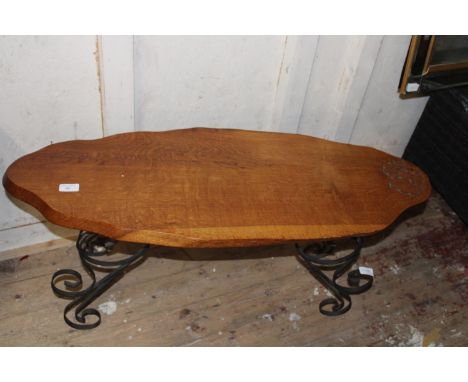 A vintage wooden table with carved acorn decoration on metal legs. Postage unavailable 93cm long 