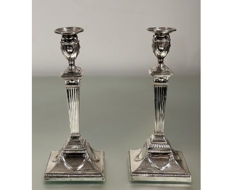 A pair of late Victorian Adam Revival silver candlesticks, Henry Wilkinson &amp; Co., London 1892 and 1893, each candle cup w