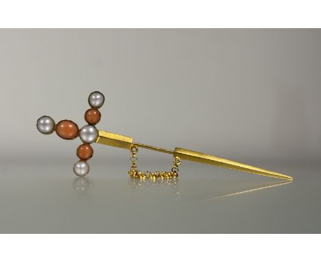 A late 19th century yellow metal jabot pin, modelled as a sword, the hilt set with half-pearls and coral beads, with safety c