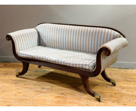 A neat Regency mahogany framed two seater scroll arm sofa, in watered silk style fabric, with reeded frame and outswept legs 