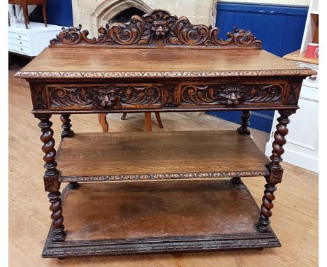 A carved oak buffet, having two drawers above shelves, 126 cm wide