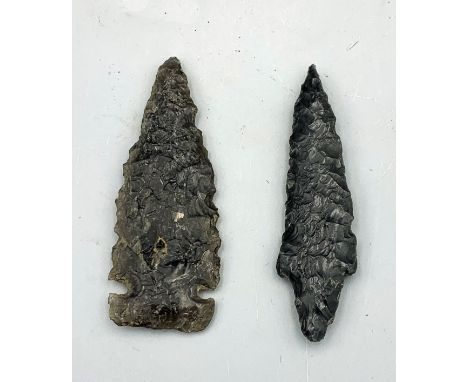 A pair of authentic black obsidian arrow heads from Western Nevada, ca. 9000 - 4000 BP. The first is an Early Archaic Norther