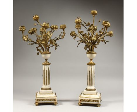 A GOOD PAIR OF LATE 19TH CENTURY MARBLE AND ORMOLU  FIVE LIGHT CANDELABRA. modelled as an urn of roses, supported on a fluted