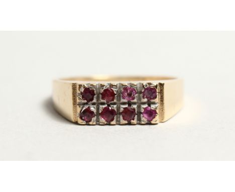 A GOLD AND TWO ROW RUBY RING.