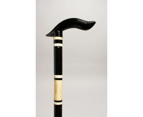 A BLACK AND WHITE WALKING STICK 36ins long.