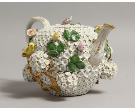 A GOOD MEISSEN PORCELAIN TEAPOT, with flowerhead decorated body, moulded flowers and a pair of birds, with naturalistic handl