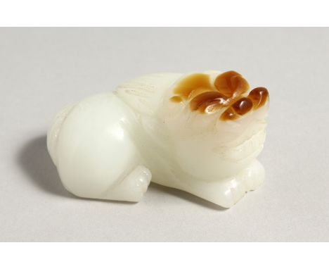 A CHINESE CARVED WHITE JADE DOG OF FOU. 3ins long