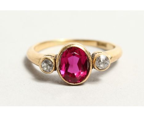 AN 18CT GOLD, DIAMOND AND RED STONE RING.