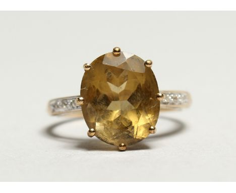A TOPAZ RING with diamond shoulders