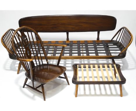 An Ercol settee with stick back sides, 74cm high x 204cm long x 73cm deep, together with a matching footstool and an Ercol ar