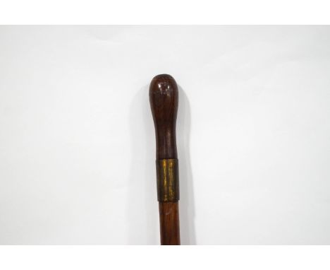 An early 20th century swordstick with turned wooden handle, the blade stamped Wilkinson, Pall Mall