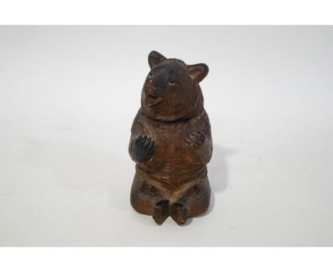 A Black Forest bear inkwell with glass liner, 12cm high