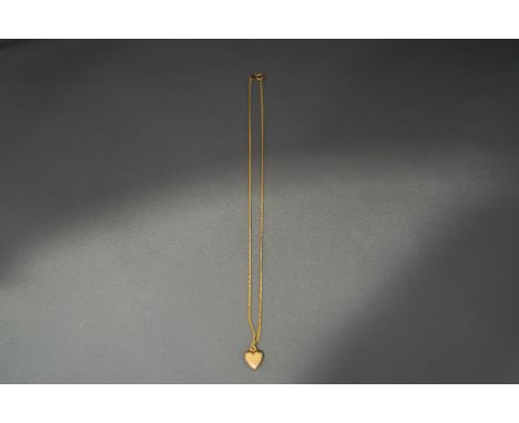 A 9 carat gold chain, of filed curb links, 51 cm long, 2.9 g gross; and a hollow heart shaped pendant