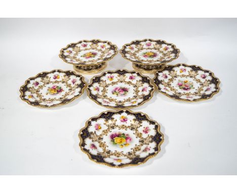 A Royal Worcester hand painted part dessert service, decorated with roses and signed by E Phillips, comprising four plates an