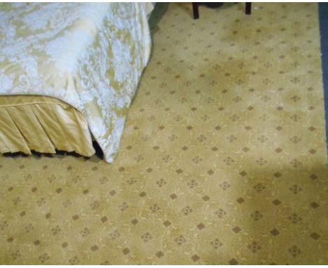 A Roll of Gold Coloured Carpet with geometric design. Approximately 10ft by 10ft. 
