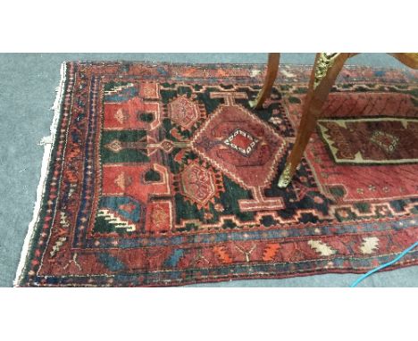 A Persian Lory Hammerdan Hand Woven Carpet, on a deep red ground, approx 9ft 8ins x 4ft 4ins.