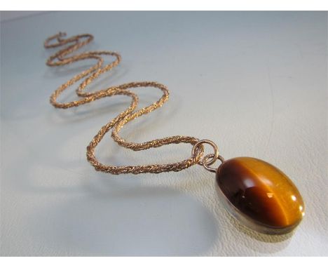 Vintage silver Tiger's eye pendant of an approx 25mm x 19mm across oval cabochon stone with the silver and GR stamped into th