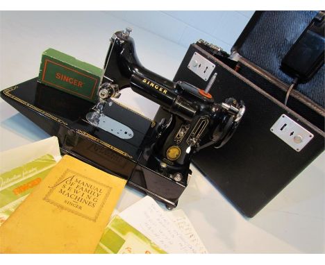 A vintage Singer portable electric sewing machine. No 222k in carry case with accessories, lead and instruction manuals.