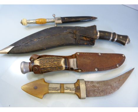 Four hand held knives - to include two Kuhkri type knives, one other with unusual handle of orange stone ending in a possible