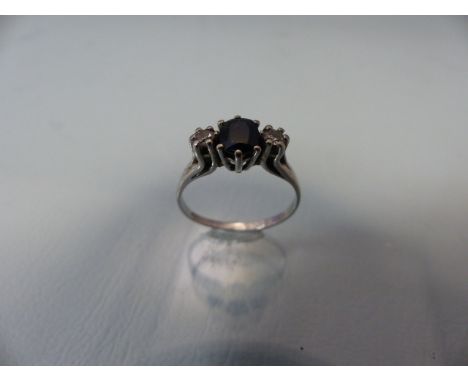 White Gold ladies dress ring with central sapphire and diamonds to shoulders (hallmarks rubbed)