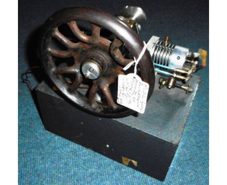 Model glow plug engine. Cam driven flywheel. Mounted on box with distributors inside. 24cm x 6cm x 28cm.