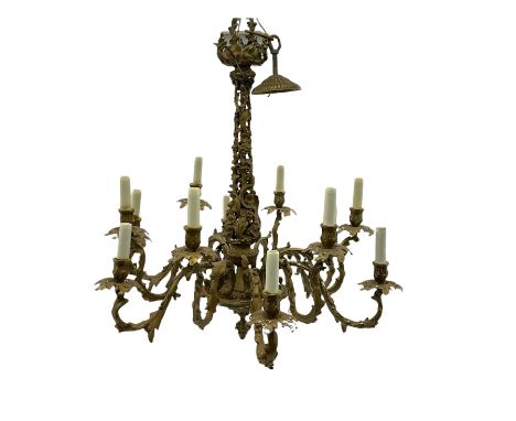 Mid to late 20th century gilt metal chandelier, on scrolled leaf and berry stem with twelve projecting serpentine leaf moulde