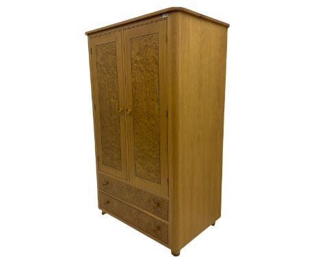 Bespoke light oak double wardrobe, with figured burr oak doors enclosing two shelves, two drawers under, raised on turned sup