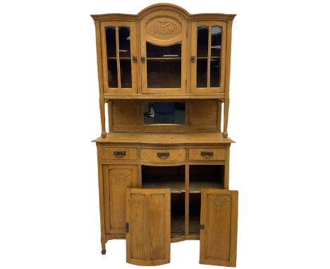 19th century elm dresser, the raised arched top enclosed by three glazed doors, the central door with floral carved panel, th