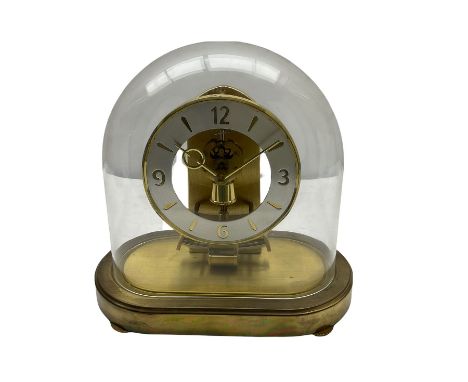A late 20th century German Kieninger &amp; Obergfell, "Kundo" battery operated mantle clock under an acrylic shade, with an e