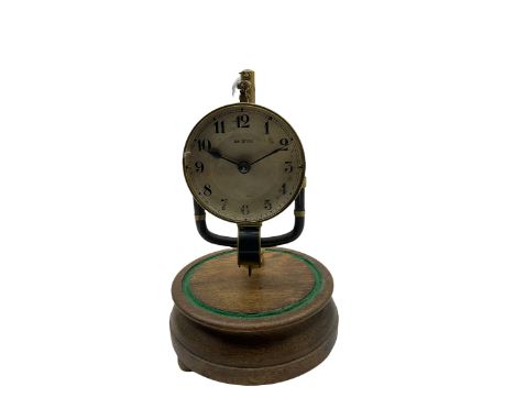 A 1920's French 800-day Bulle electric battery clock on a turned wooden base, with a circular silvered dial with Arabic numer