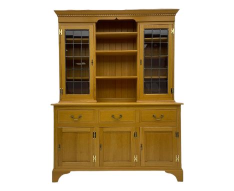 Solid light oak dresser, fitted with three drawers and three fielded panel doors, upper lead glazed display doors with open c