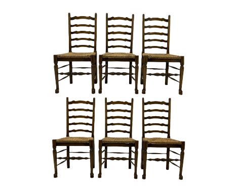 Set of six 18th century style oak dining chairs with waved ladder backs and drop in rush seats