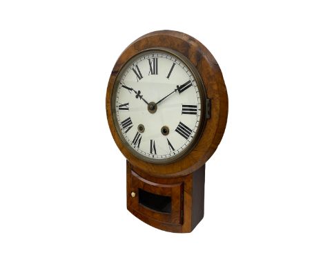 A late 19th century American drop dial wall clock in a walnut case, with an 8-day striking movement striking the hours and ha