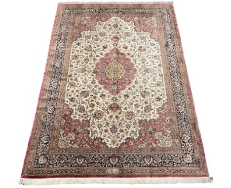 Finely knotted Persian Qom silk rug, overall pink ground with ivory field, the field with central cusped medallion profusely 