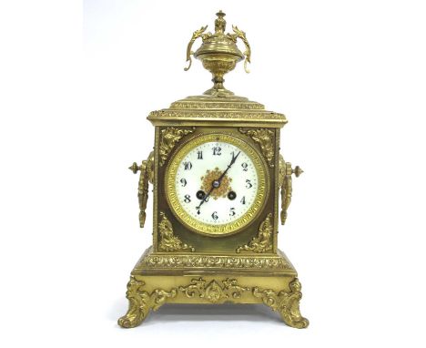 A Late XIX Century Brass Cased Mantle Clock, elaborately cast and applied with scrollwork, the urn surmount above a rectangul