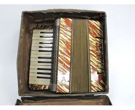 An Estrella Piano Accordion, with gold and brown lacquered body, cased.