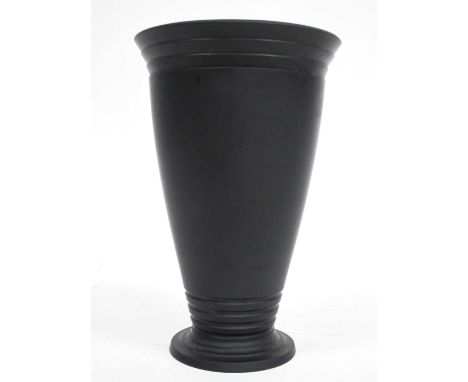 A Keith Murray for Wedgwood Black Basalt Vase, of tapered footed form, the lower and upper section with moulded bands, impres
