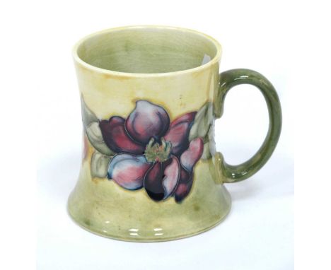 A Moorcroft Pottery Tankard, of waisted form painted in the 'Clematis' pattern against a yellow ground, impressed marks, 9cm 