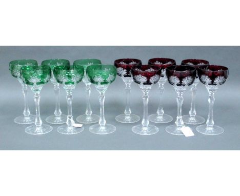 A Set of Six Cut Glass Hock Glasses, the dark ruby flashed bowls cut with flower heads on fluted stem and circular foot and a