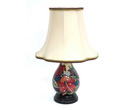 A Moorcroft Pottery Table Lamp, of ovoid form, painted in the 'Simeon' pattern, mounted on a wood base, with shade, 19cm high