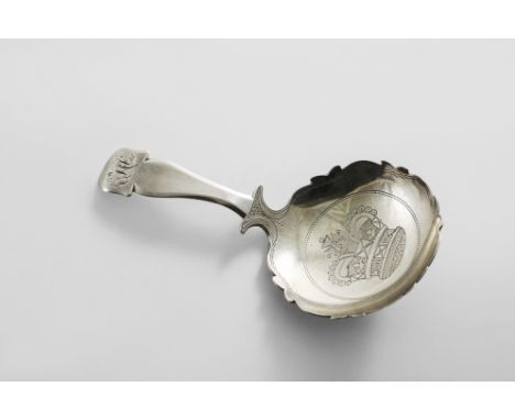 A GEORGE III CADDY SPOON with a shaped and chamfered stem and a shaped circular bowl with pricked borders, engraved in the ce