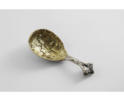 A VICTORIAN PARCELGILT CADDY SPOON cast, with a naturalistic matted leaf bowl handle, with a shaped terminal and vacant carto