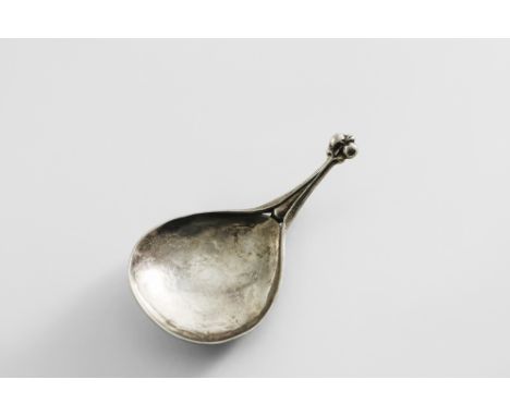 AN ARTS &amp; CRAFTS CADDY SPOON with a hammered, drop-shaped bowl, a bifurcated stem with a rattail at the back and a fleur-