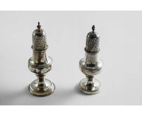 A GEORGE III PEPPER CASTER with a wrythen finial and bead borders, crested, by Hester Bateman, London 1781 and another simila